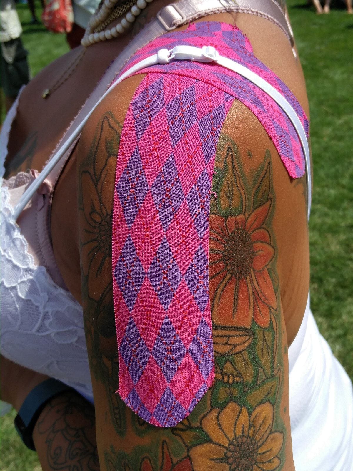 A roll of patterned kinesiology tape, an everyday tool of sports therapy and athletic care